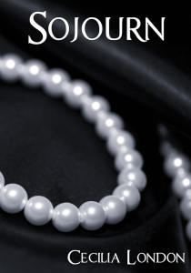 A pearl necklace on a black silk macro